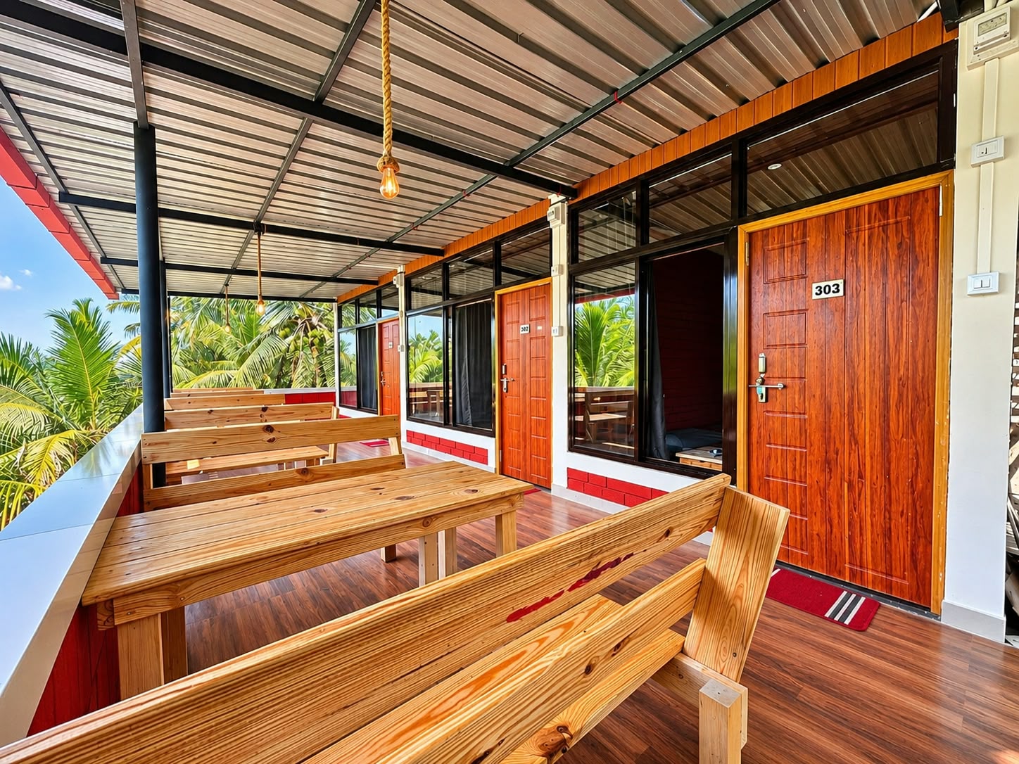 Homestay balcony with wooden benches and palm views